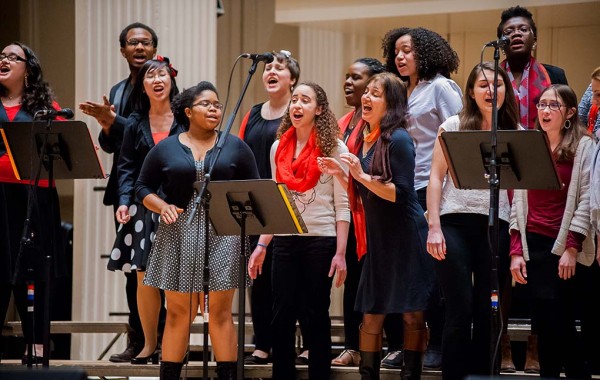 Choir singing on the stage of Colgate Memorial Chapel