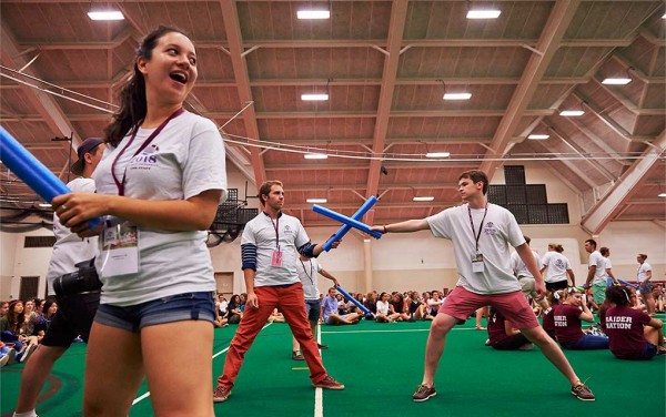 Students joust with foam swords in Sanford Fieldhouse