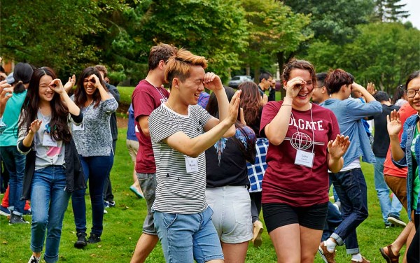 Students look through their hands during an ice breaking activity