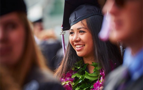 Student with flowery leis in graduation garb