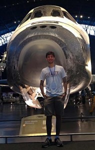 Warren Dennis '16 in front of space shuttle
