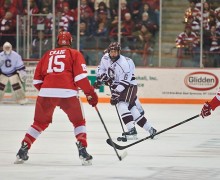 Colgate player has possession of the puck against Cornell