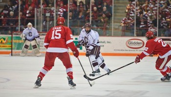 Colgate player has possession of the puck against Cornell