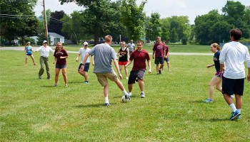 Faculty and students play soccer