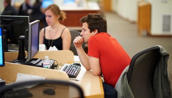 Student concentrating while working at a computer