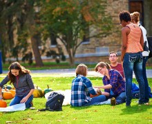 Colgate students carve pumpkins on the Academic Quad