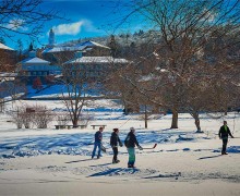 Students play hockey on a frozen Taylor Lake