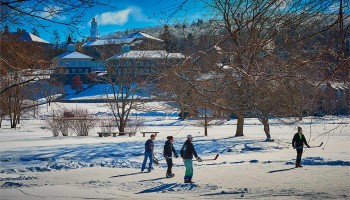 Students play hockey on a frozen Taylor Lake