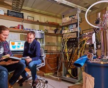 Segall and his student Matt LeGro ’15 sit near helium condensing equipment
