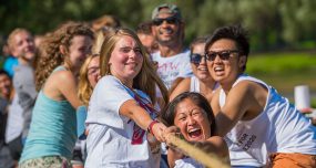 First-year students smile and strain during a tug of war competition