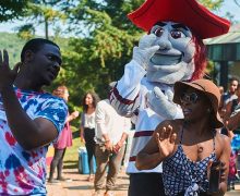 Students dancing with the Colgate Raider mascot outside ALANA.