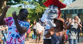 Students dancing with the Colgate Raider mascot outside ALANA.
