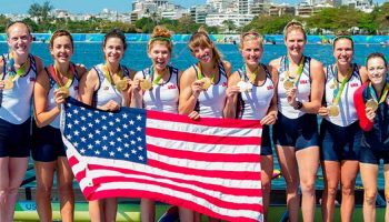 Lauren Schmetterling ’10, fourth from left, standing with gold medal with her rowing teammates