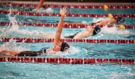 Female swimmers in the pool, mid-race