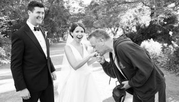 Tom Hanks kisses the hand of Elisabeth Murphy ’11 while her new husband Ryan Barclay smiles in astonishment
